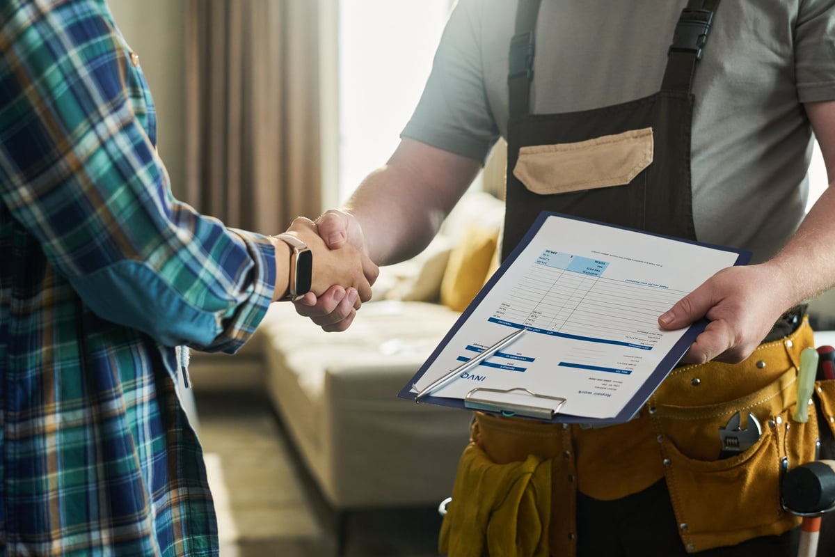 Professional contractor shaking hands with customer